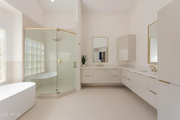 a bathroom with a tub sink shower and mirror