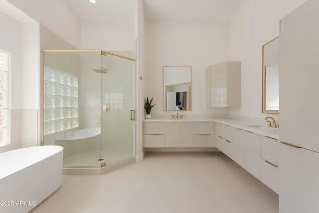 a bathroom with a tub sink shower and mirror