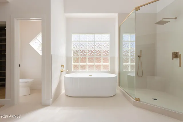 a bathroom with a bathtub and toilet