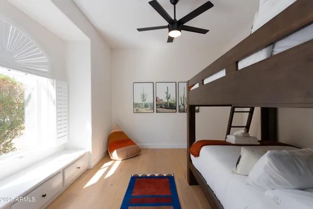 a bedroom with a large bed and a large window