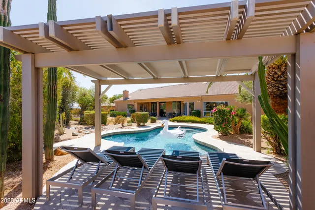 a view of swimming pool with outdoor seating