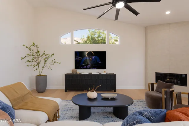 a living room with furniture a fireplace and a flat screen tv