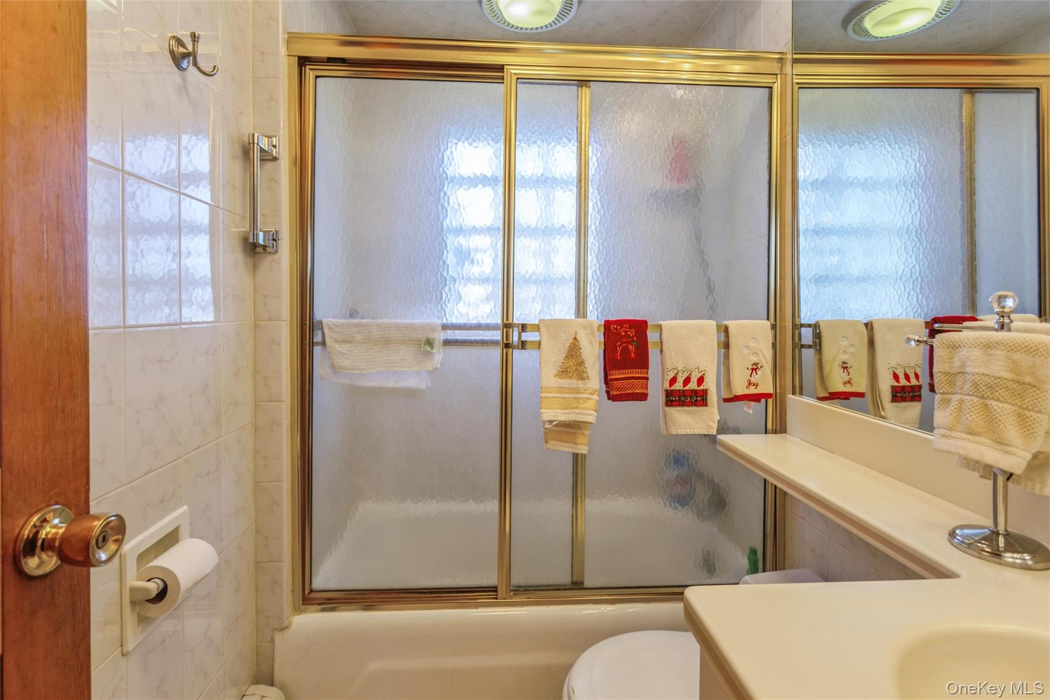 73 Parma Road Island Park, NY 11558 - Photo 11 of 37 a bathroom with a tub and a shower