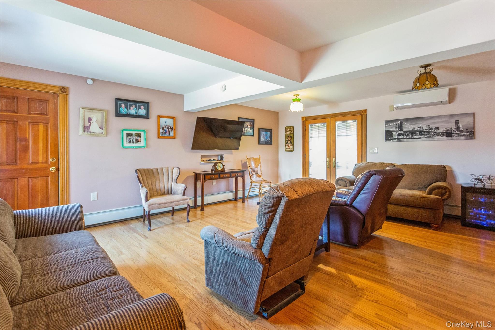 73 Parma Road Island Park, NY 11558 - Photo 12 of 37 a living room with furniture and a flat screen tv