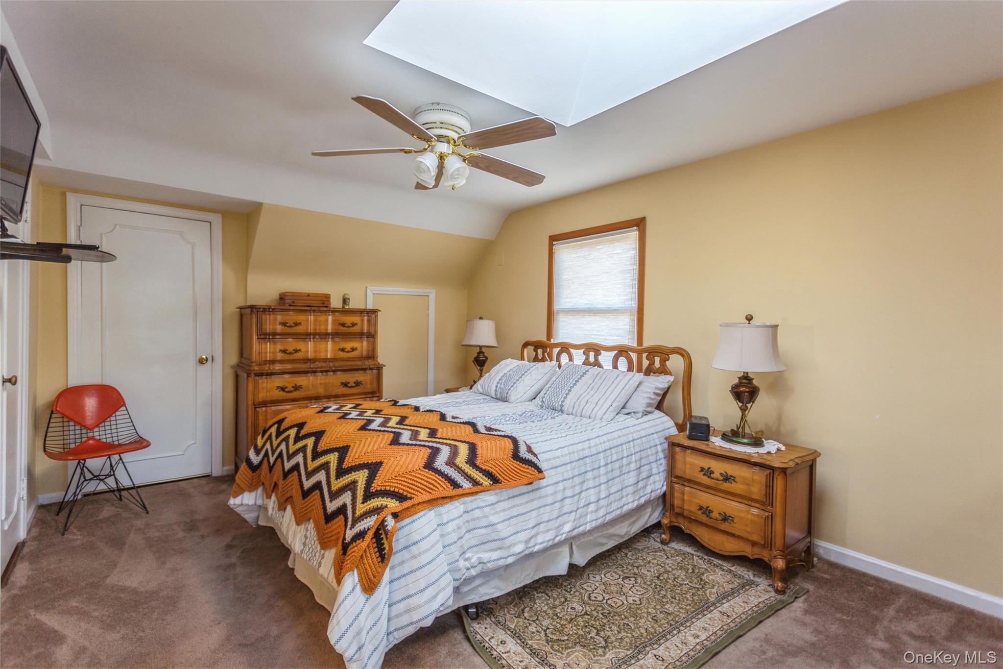 73 Parma Road Island Park, NY 11558 - Photo 19 of 37 a bedroom with a bed and a chandelier