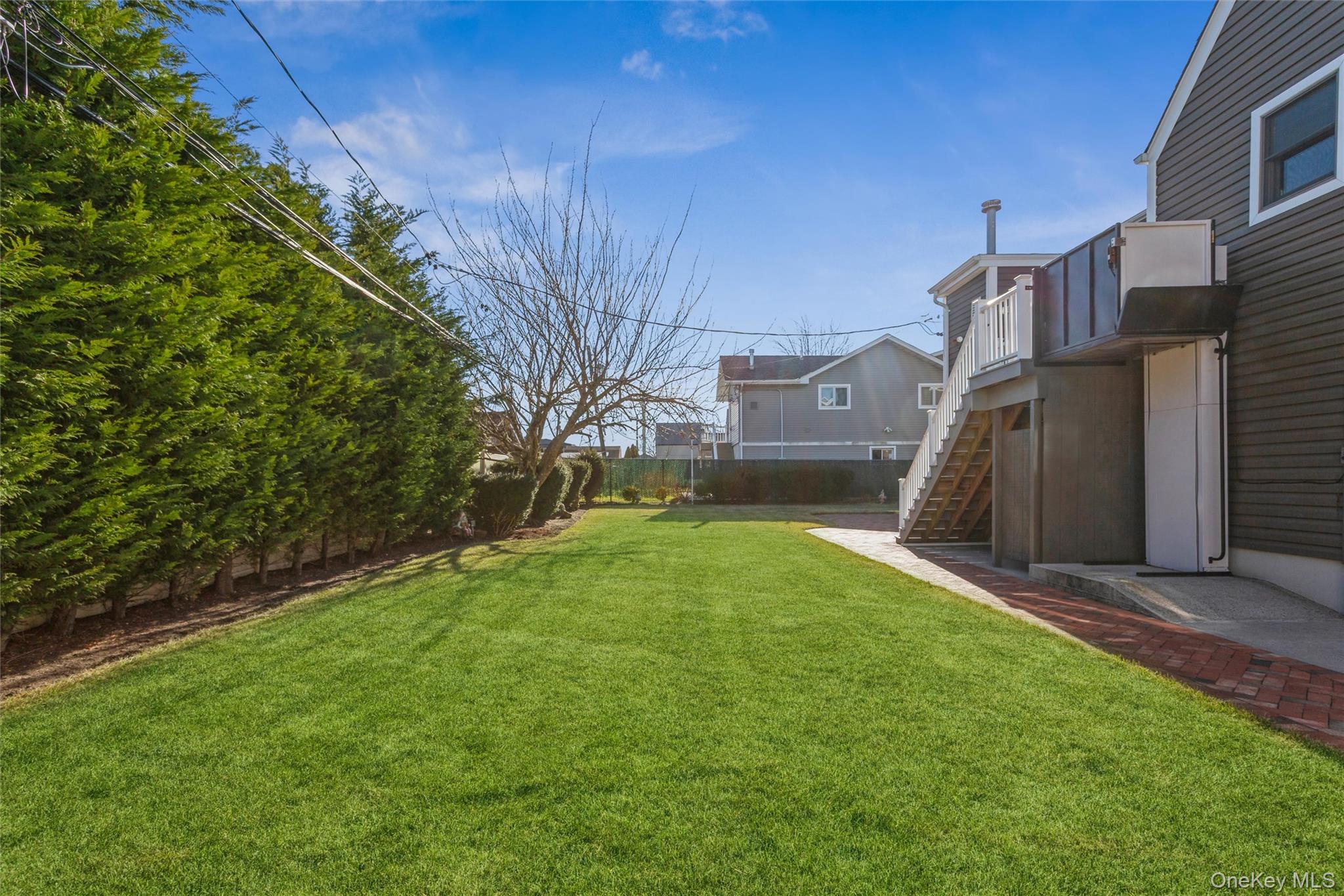 73 Parma Road Island Park, NY 11558 - Photo 30 of 37 a view of a backyard with a large tree