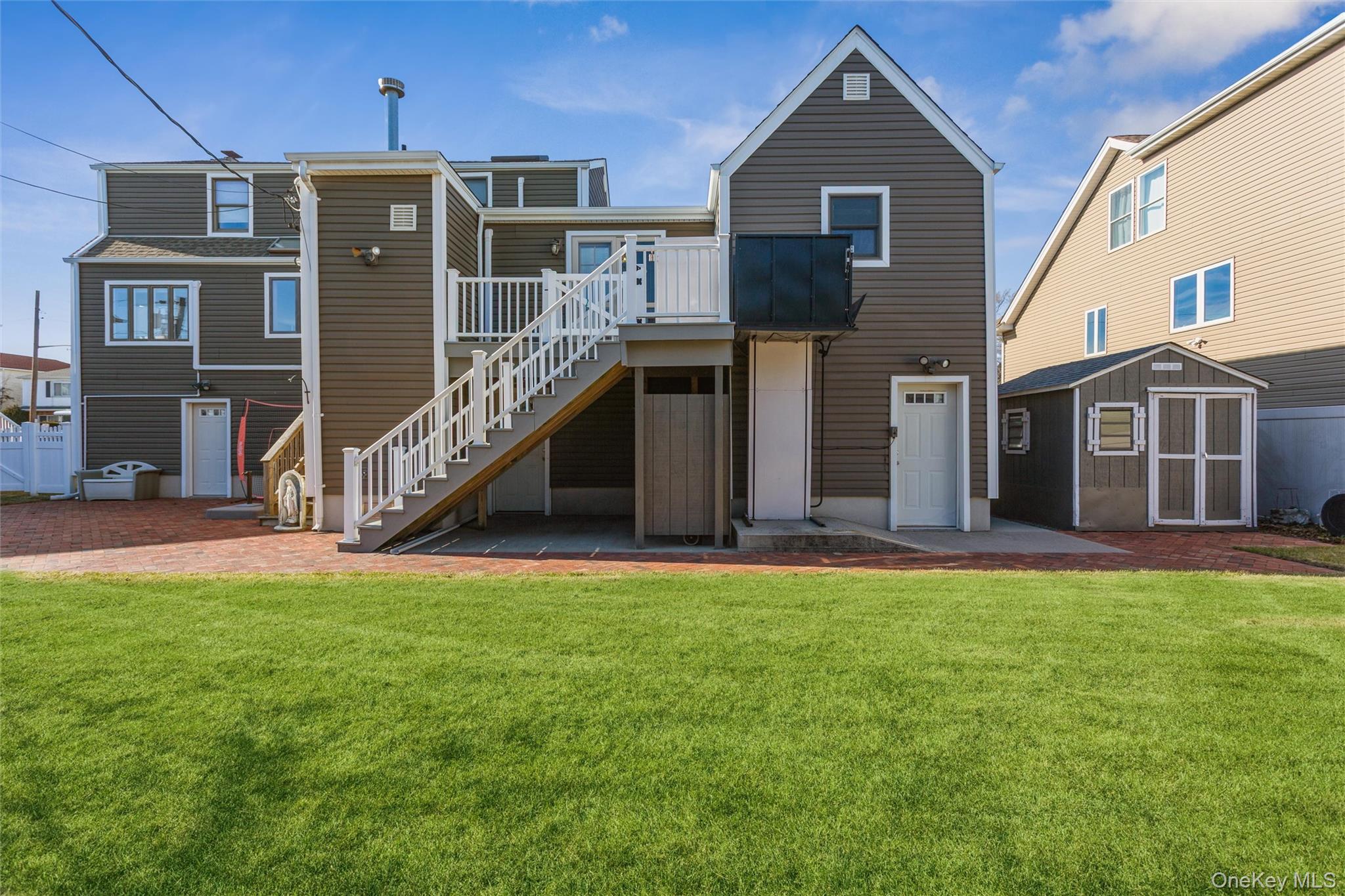 73 Parma Road Island Park, NY 11558 - Photo 31 of 37 a front view of a house with a yard