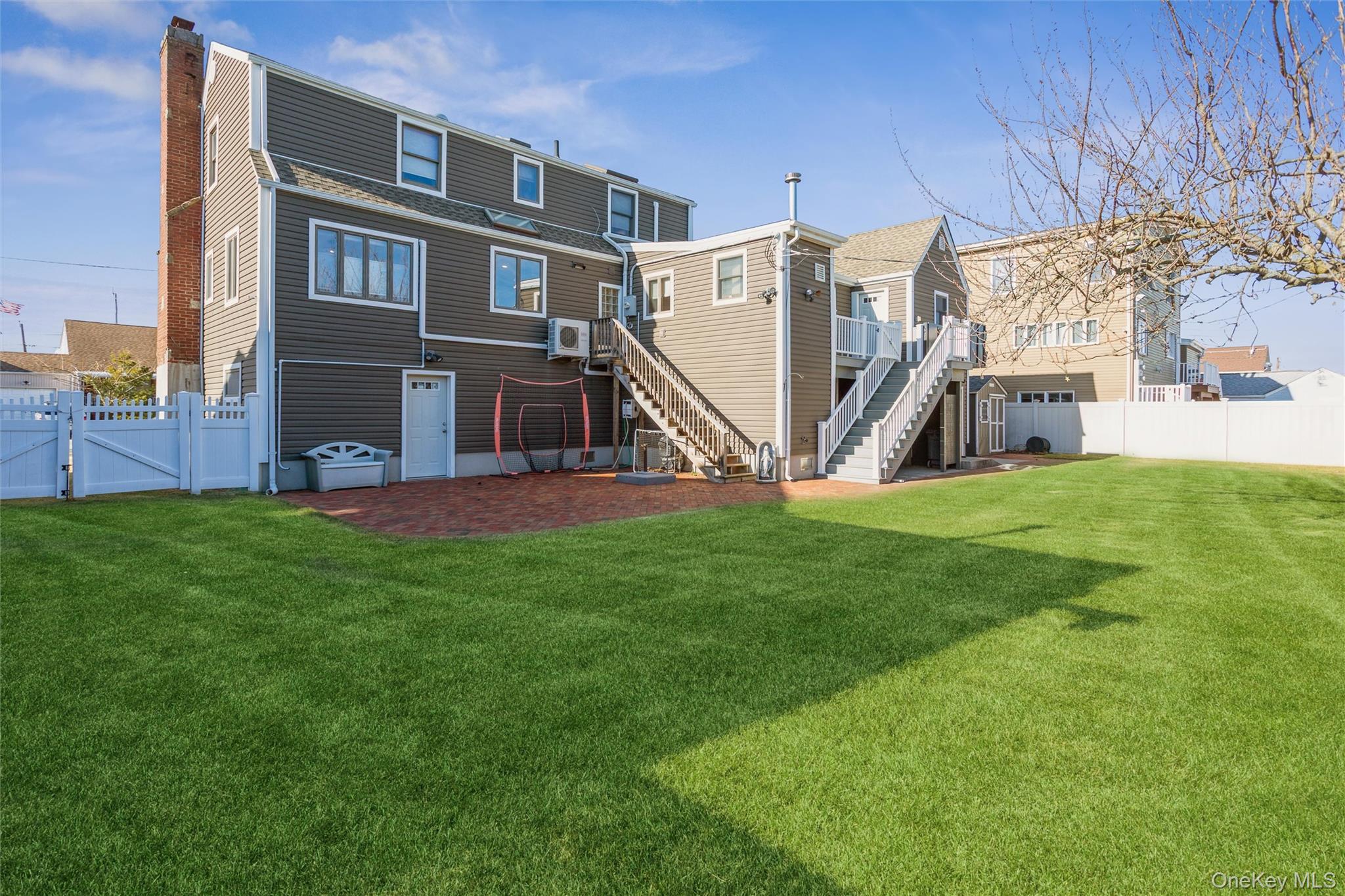 73 Parma Road Island Park, NY 11558 - Photo 32 of 37 a view of a house with a yard and a slide