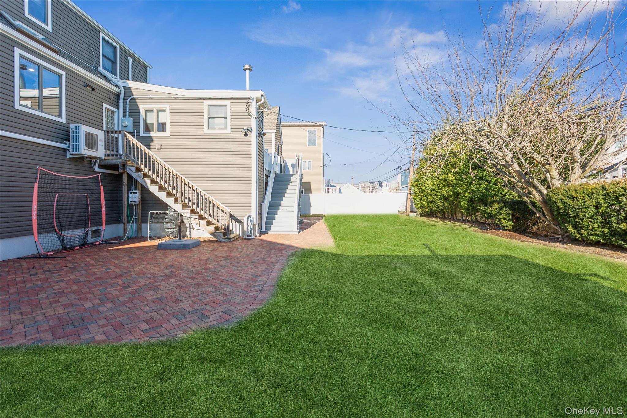 73 Parma Road Island Park, NY 11558 - Photo 33 of 37 a view of a house with a back yard