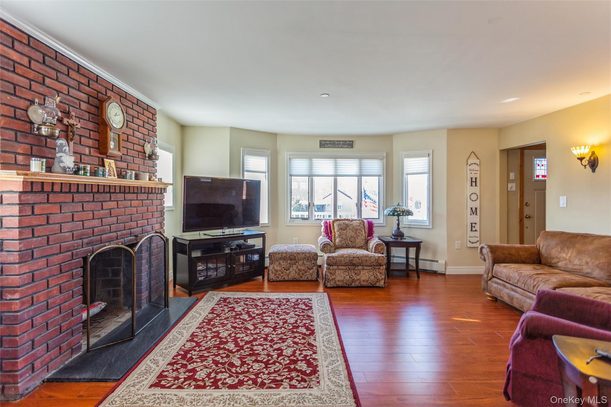 73 Parma Road Island Park, NY 11558 - Photo 4 of 37 a living room with furniture and a flat screen tv