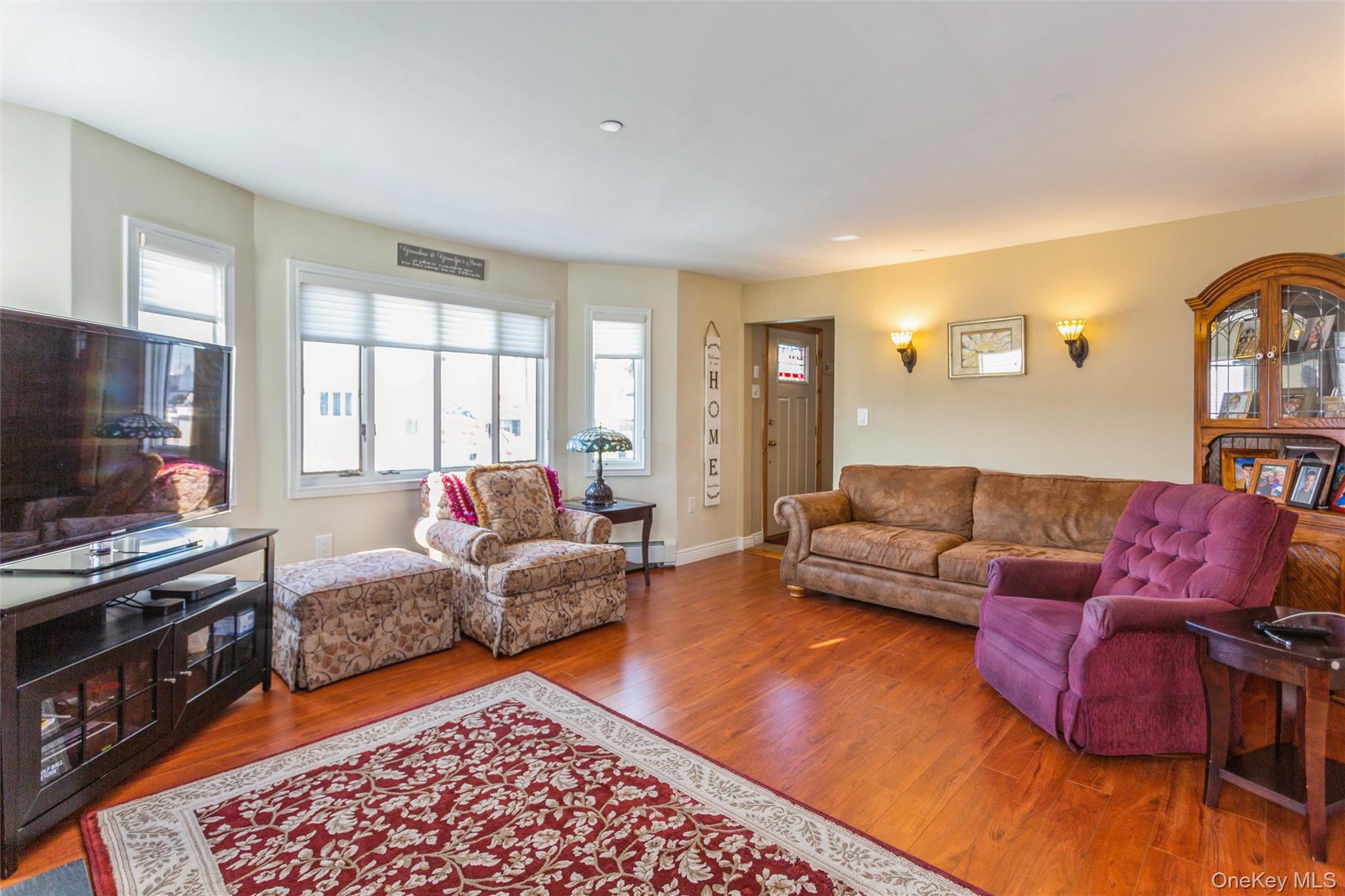 73 Parma Road Island Park, NY 11558 - Photo 5 of 37 a living room with furniture and a flat screen tv