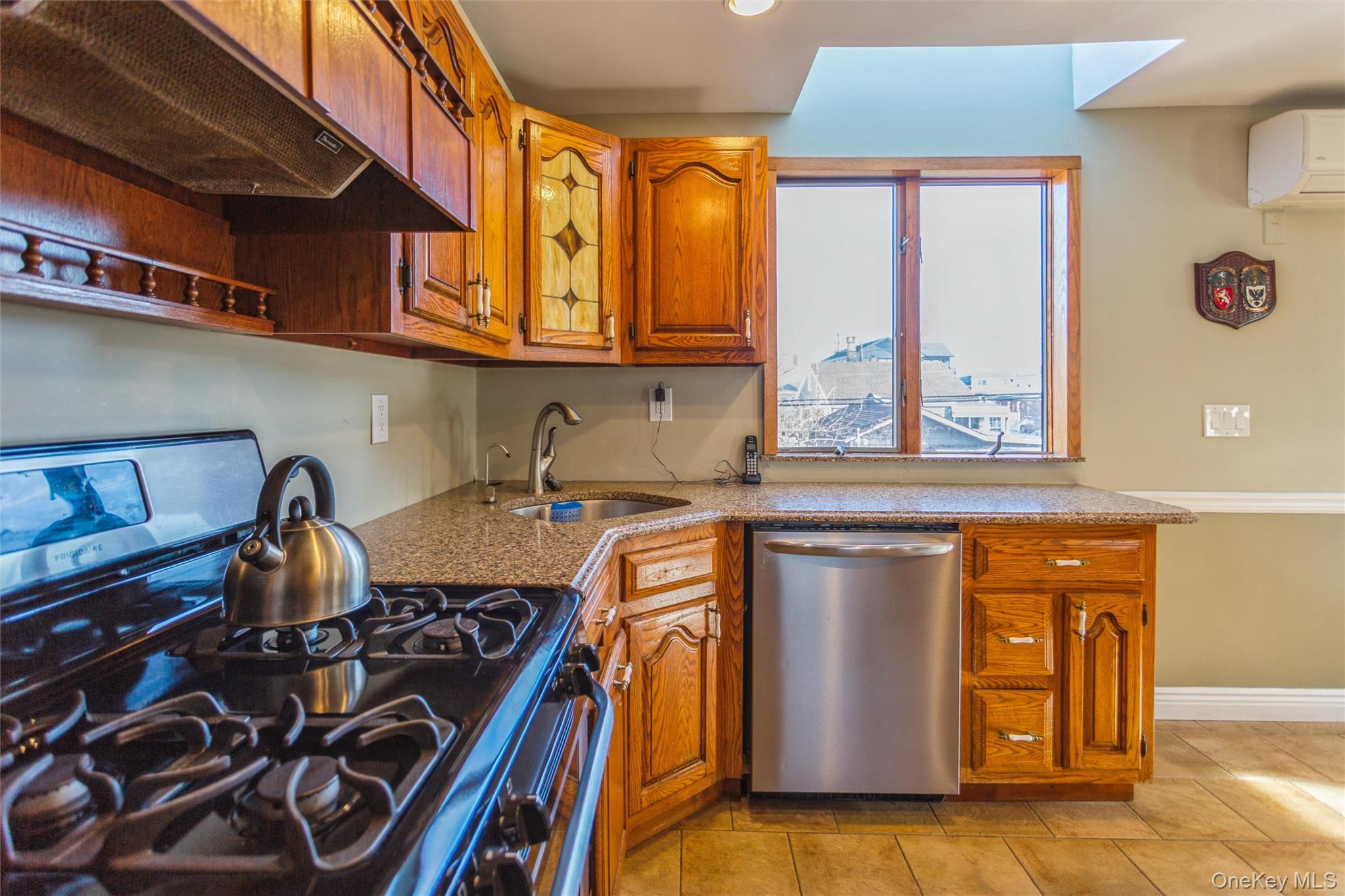 73 Parma Road Island Park, NY 11558 - Photo 9 of 37 a kitchen with stainless steel appliances granite countertop a stove a sink and a microwave