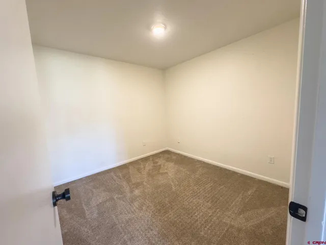 an empty room with a empty space and windows
