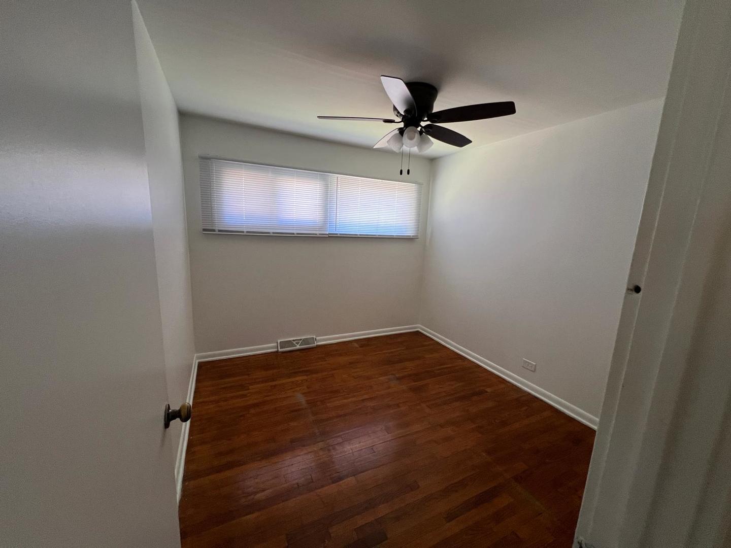 16442 Honore Avenue Markham, IL 60428 - Photo 4 of 16 a view of room with a ceiling fan and hardwood floor