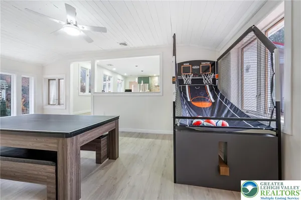 a view of a kitchen with stainless steel appliances granite countertop a stove and a wooden floors