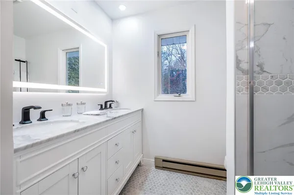 a bathroom with a sink a vanity and a mirror