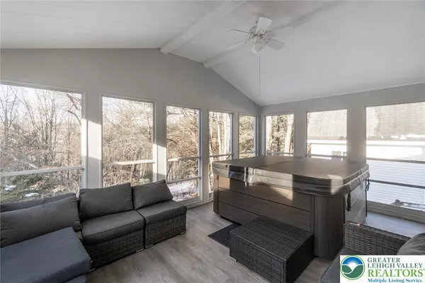 a living room with furniture and a floor to ceiling window