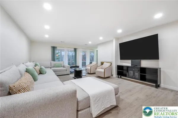 a spacious bedroom with a bed and a flat screen television