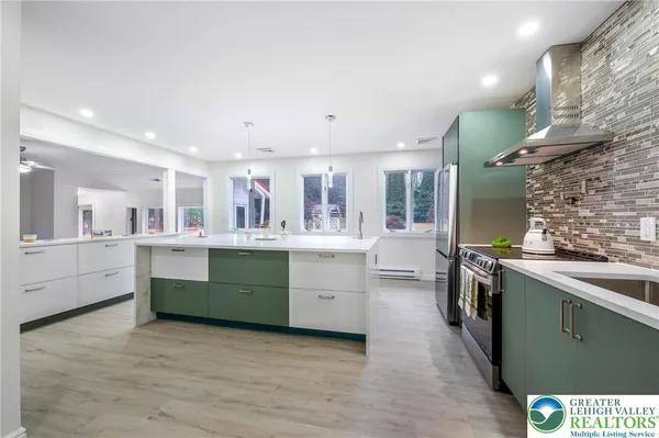 a kitchen with stainless steel appliances granite countertop a sink and stove top oven