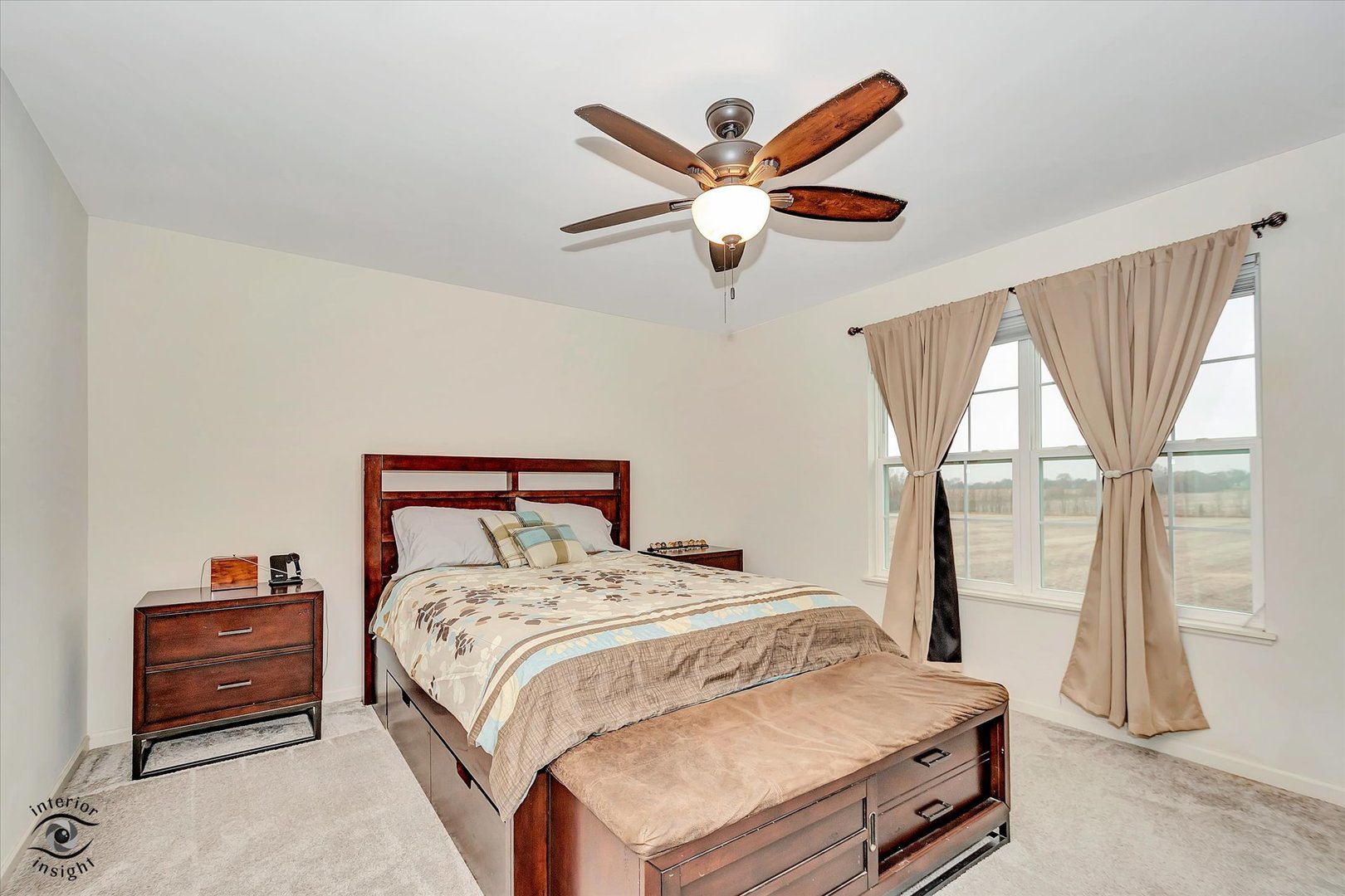 15101 Quincy Way Manhattan, IL 60442 - Photo 18 of 28 a bedroom with a bed and a chandelier