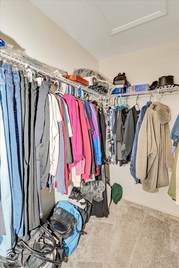 15101 Quincy Way Manhattan, IL 60442 - Photo 22 of 28 a view of walk in closet with clothes