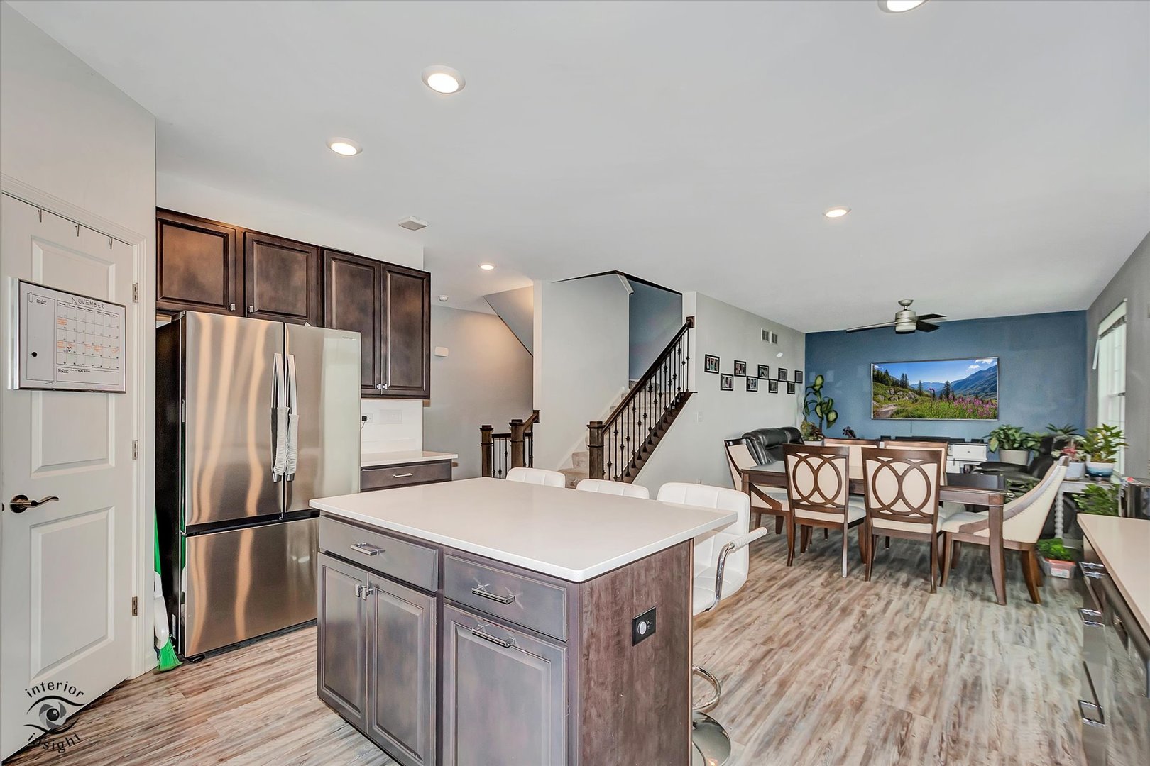 15101 Quincy Way Manhattan, IL 60442 - Photo 10 of 28 a kitchen with a table chairs refrigerator and wooden floor