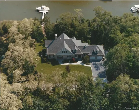 an aerial view of a house with yard swimming pool and outdoor seating