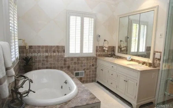 a bathroom with a granite countertop sink a toilet and bathtub