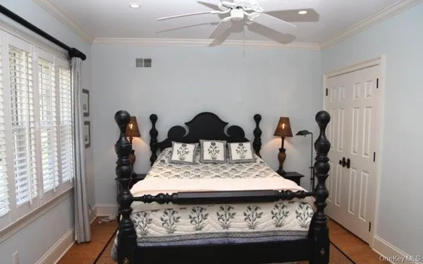 a bed sitting in a bedroom next to a window