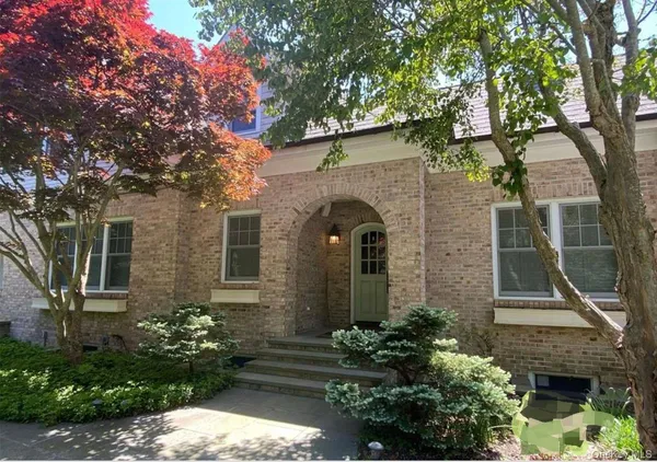 front view of a house with a garden