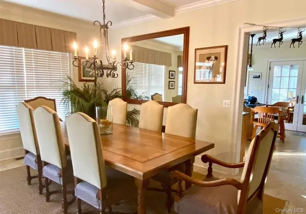 a view of a dining room with furniture and chandelier