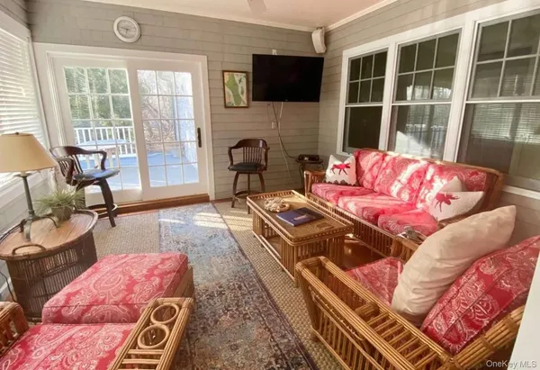 a living room with furniture fireplace and flat screen tv