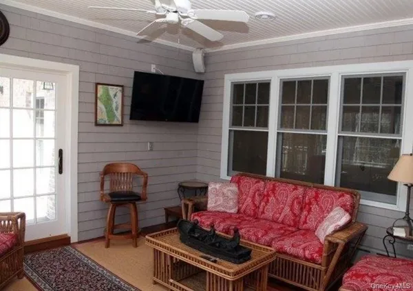 a living room with furniture a flat screen tv and a fireplace