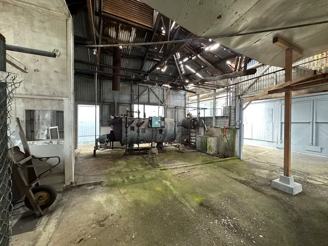 a view of a garage with wooden table and chairs