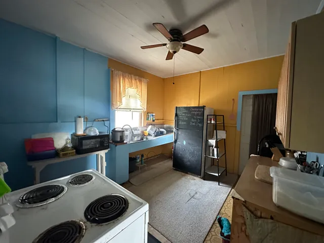 a kitchen with a stove a refrigerator and a sink
