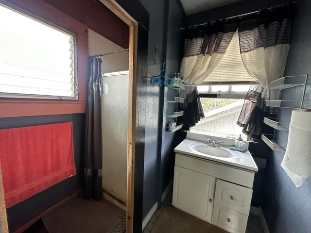 a view of a livingroom with workspace and a window
