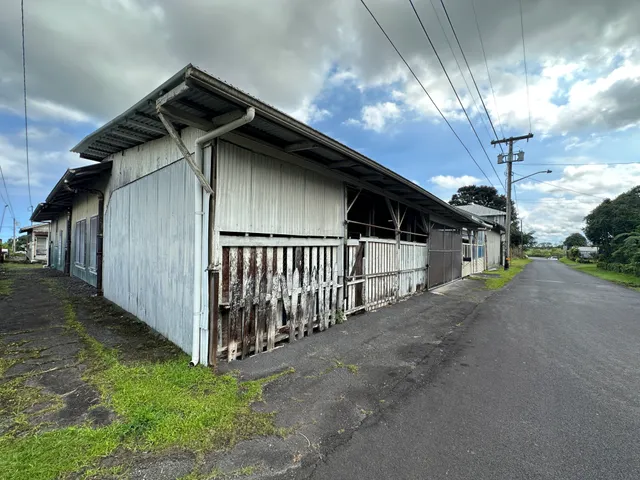 a view of a house with a small yard and wooden fence