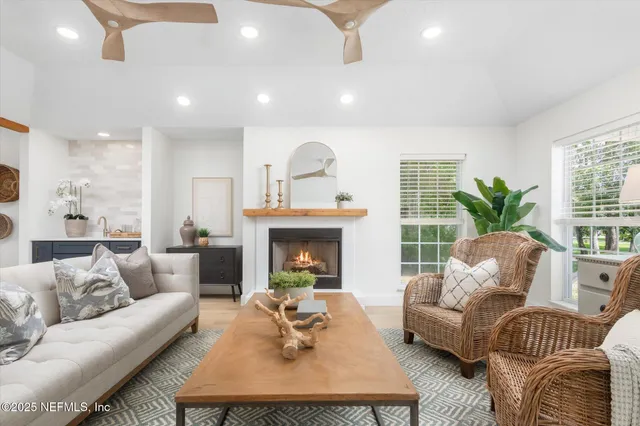 a living room with furniture fireplace and window