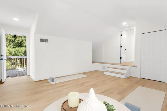 an aerial view of residential houses with outdoor space and river