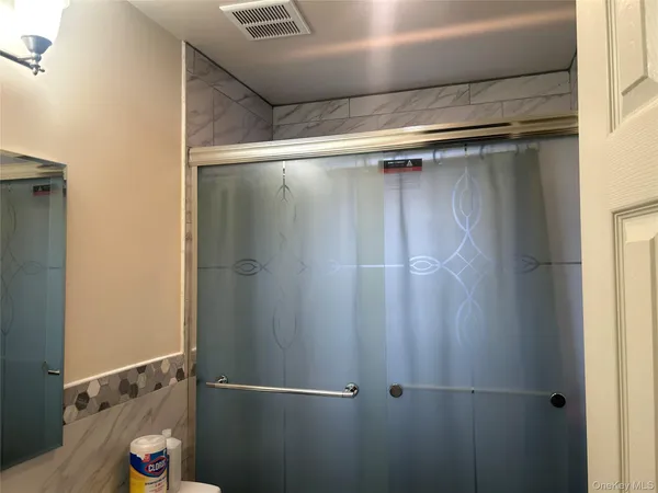 a bathroom with a glass shower door