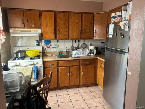 a kitchen with a refrigerator and cabinets