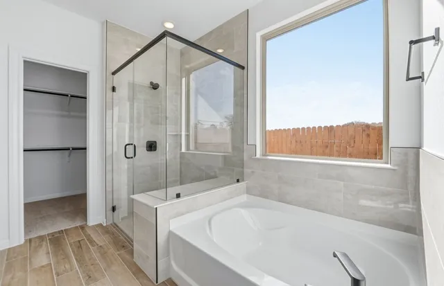 a bathroom with a bathtub and a shower