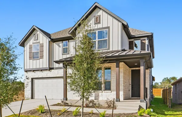 a view of a brick house with large windows