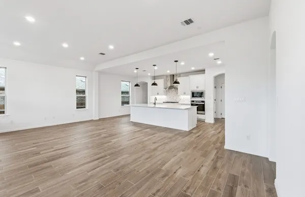 a view of kitchen with kitchen island and stainless steel appliances
