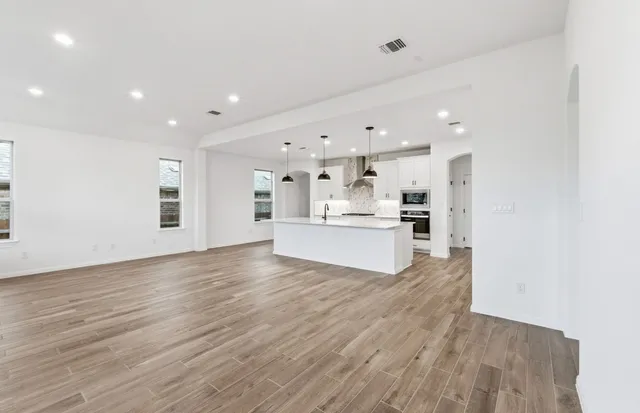 a view of kitchen with kitchen island and stainless steel appliances