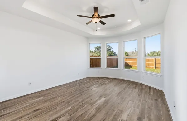 wooden floor in an empty room with a window