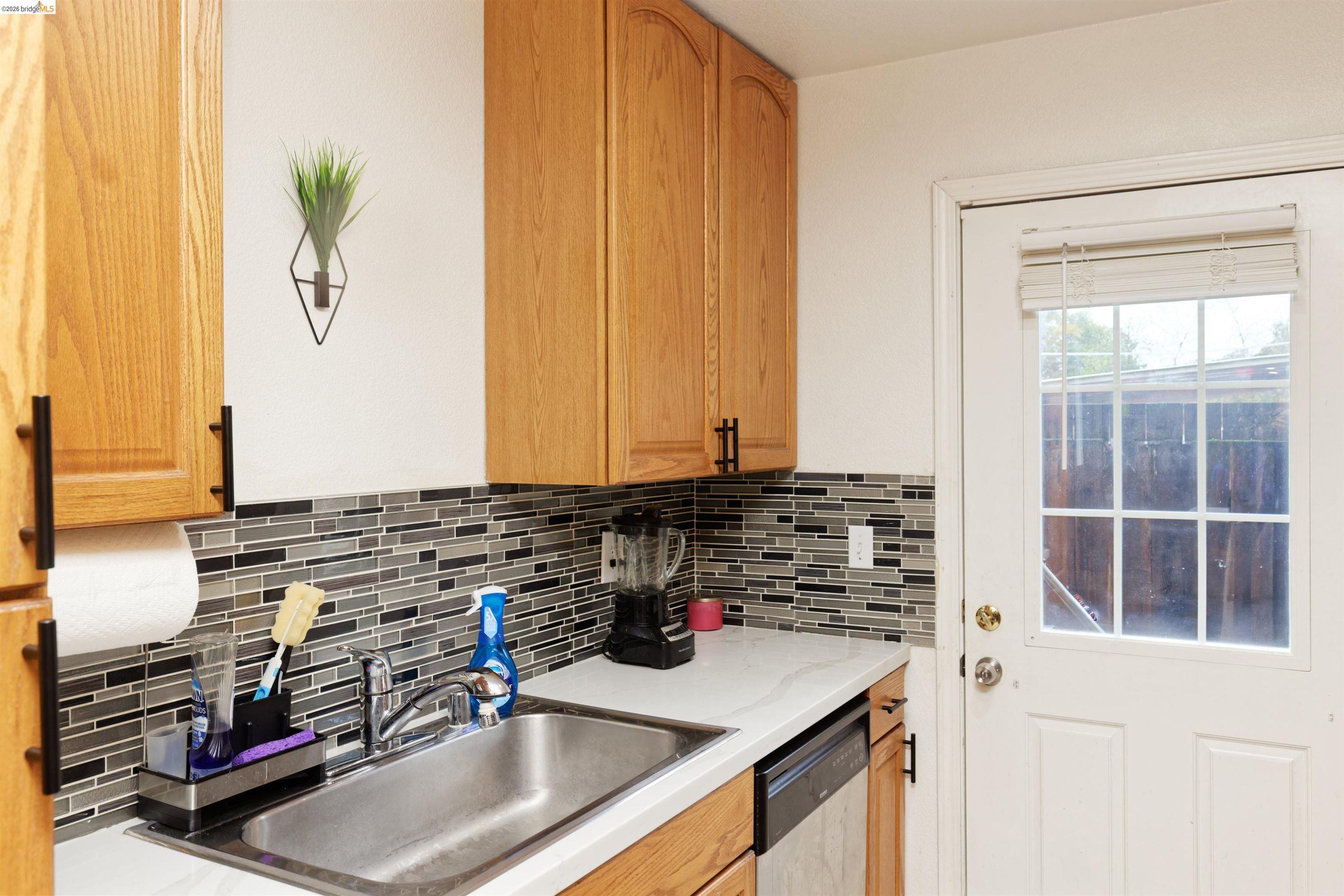 10 Leighty Court, Unit 5 Hayward, CA 94541 - Photo 13 of 22 Kitchen featuring dishwasher, wood finish cabinetry, and tasteful backsplash