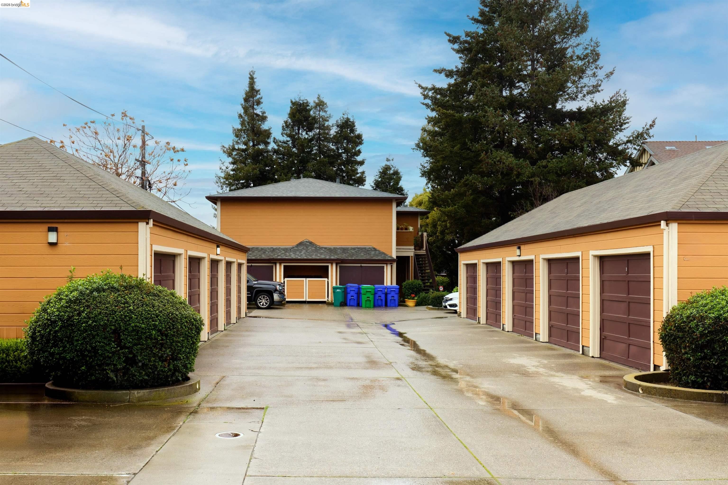 10 Leighty Court, Unit 5 Hayward, CA 94541 - Photo 4 of 22 View of property exterior with community garages and an outbuilding