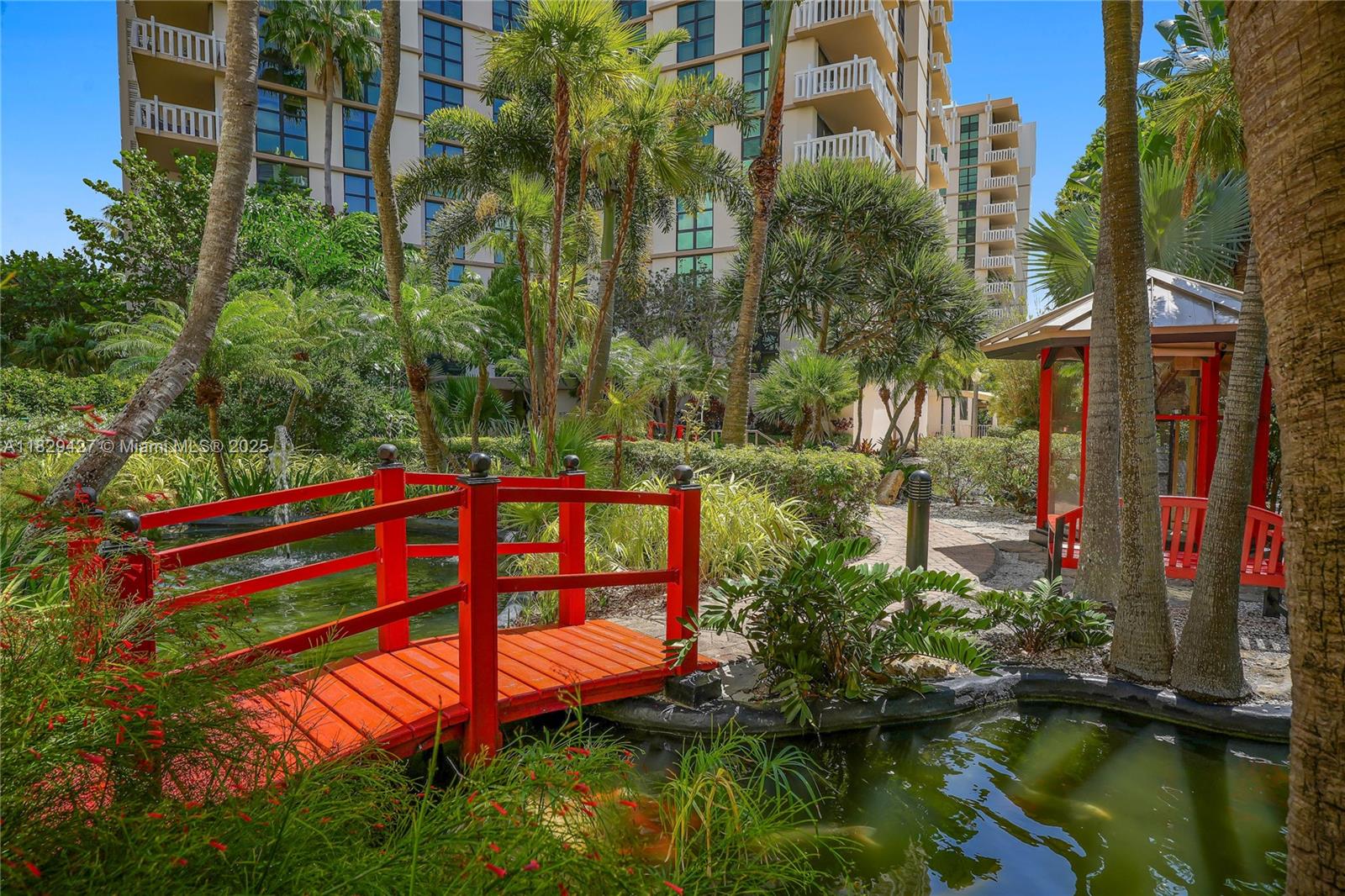 1121 Crandon Boulevard, Unit F201 Key Biscayne, FL 33149 - Photo 18 of 56 a view of a yard with plants and a bench