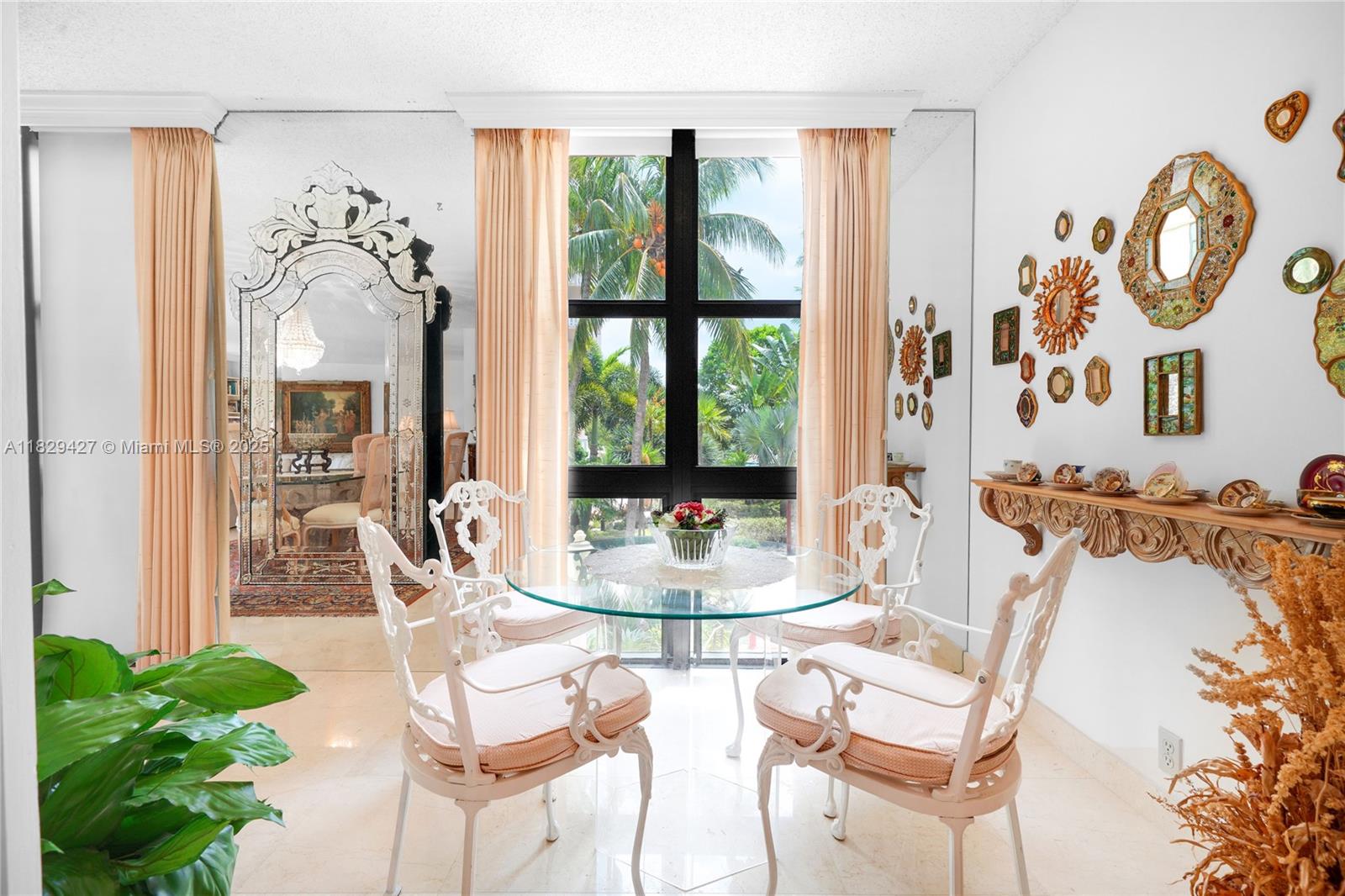1121 Crandon Boulevard, Unit F201 Key Biscayne, FL 33149 - Photo 24 of 56 a dining room with furniture a large window and plants